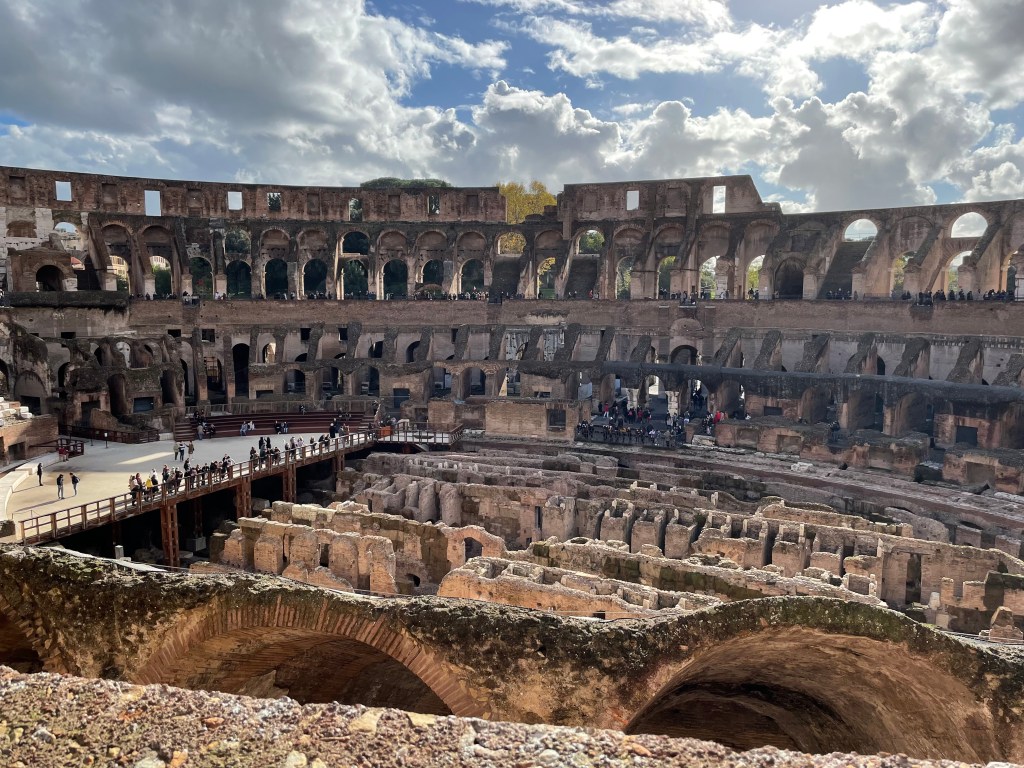 The interior of the Colosseum, in which you can see the labyrinth of chambers beneath where the gladiators fought, as well as the rows of stands.