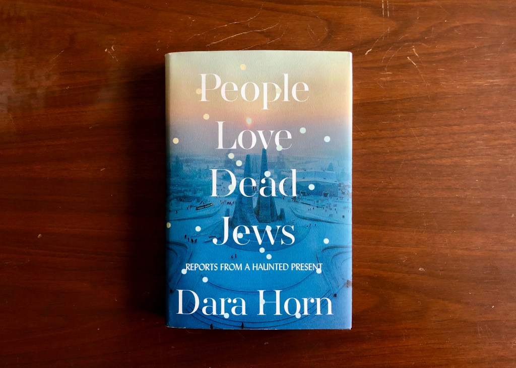 A book on a table is titled "People Love Dead Jews: Reports from a Haunted Present," by Dara Horn